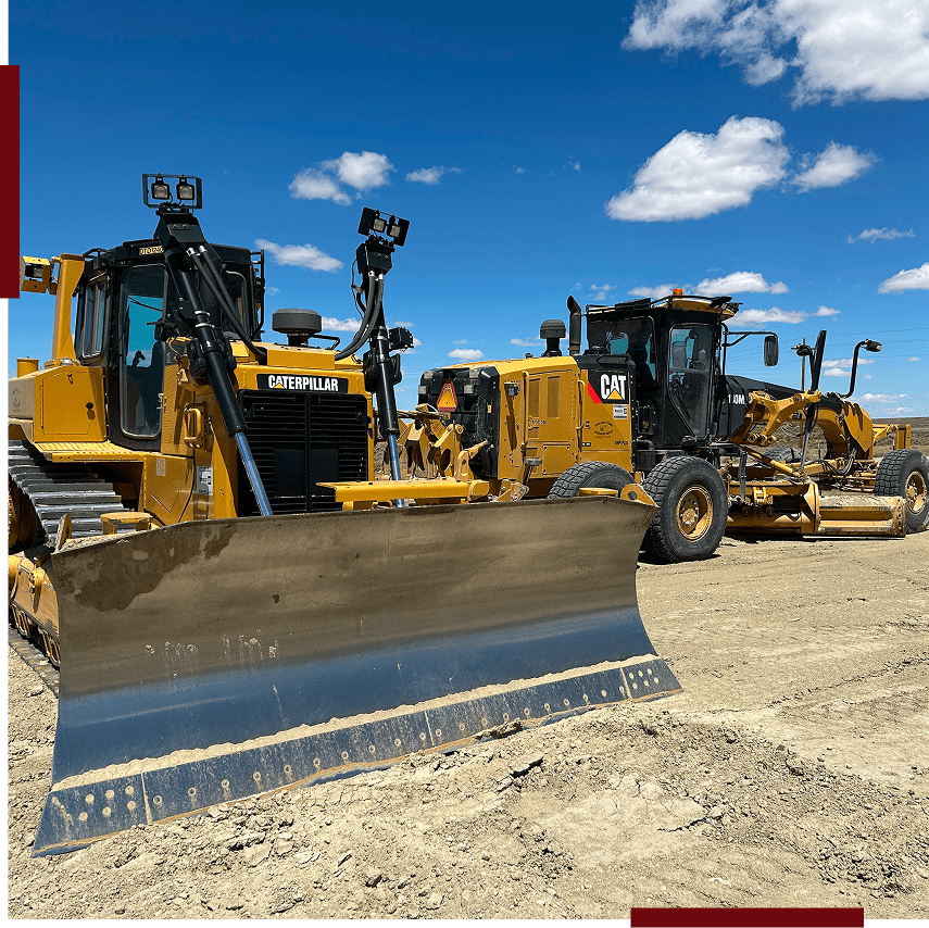 Construction machinery on a dirt site.