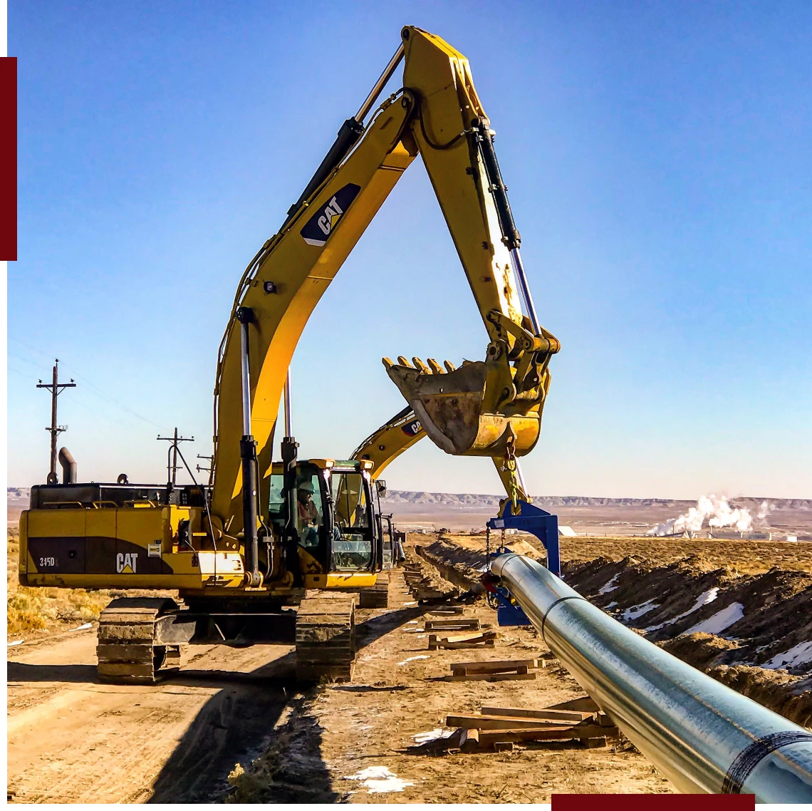 Excavator installing pipeline in rural area.